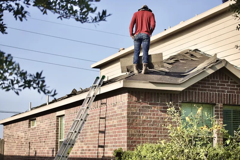 Professional roofer working on a residential roof in South Addison